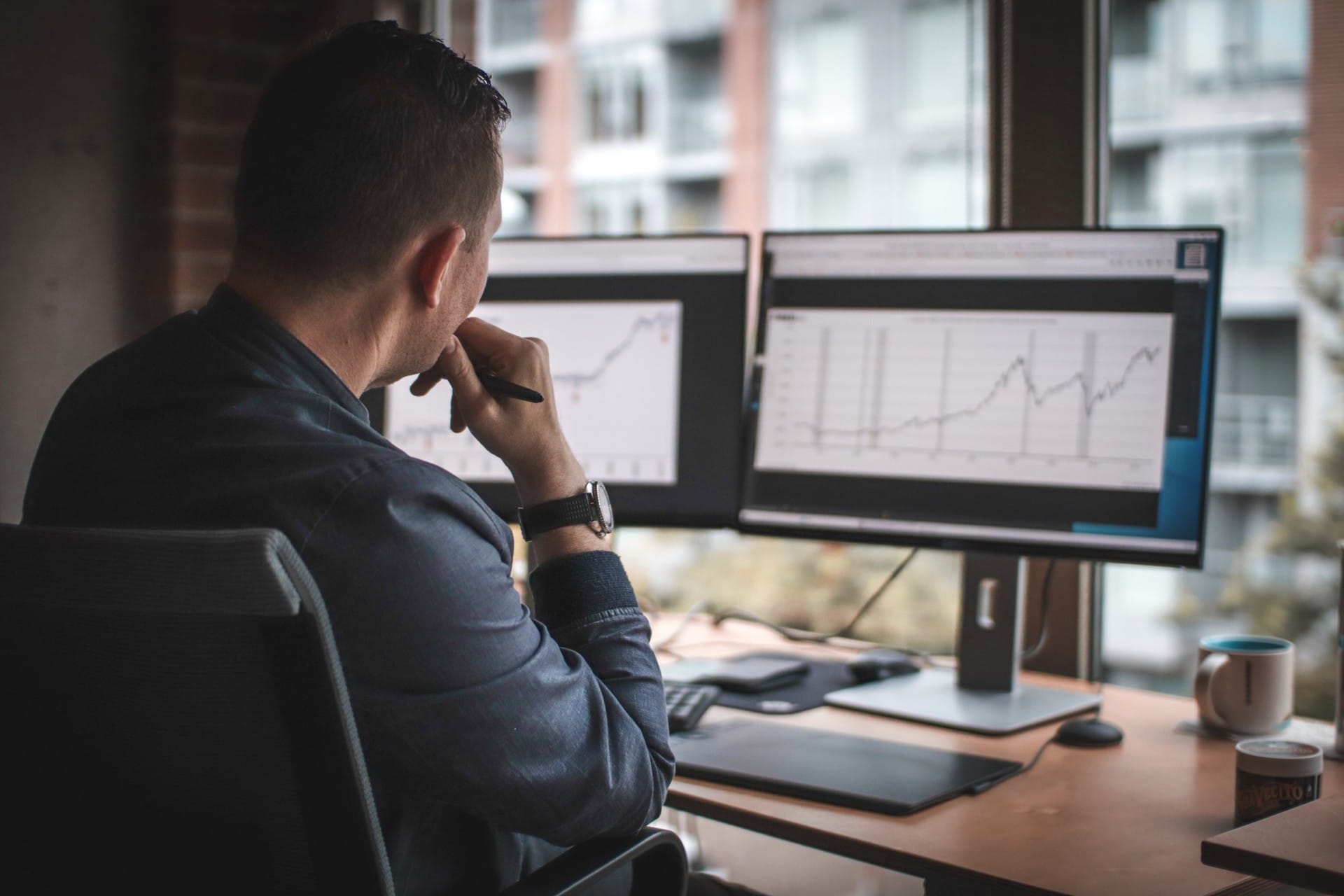 A man reviewing financial forecasts at his desk for financial planning