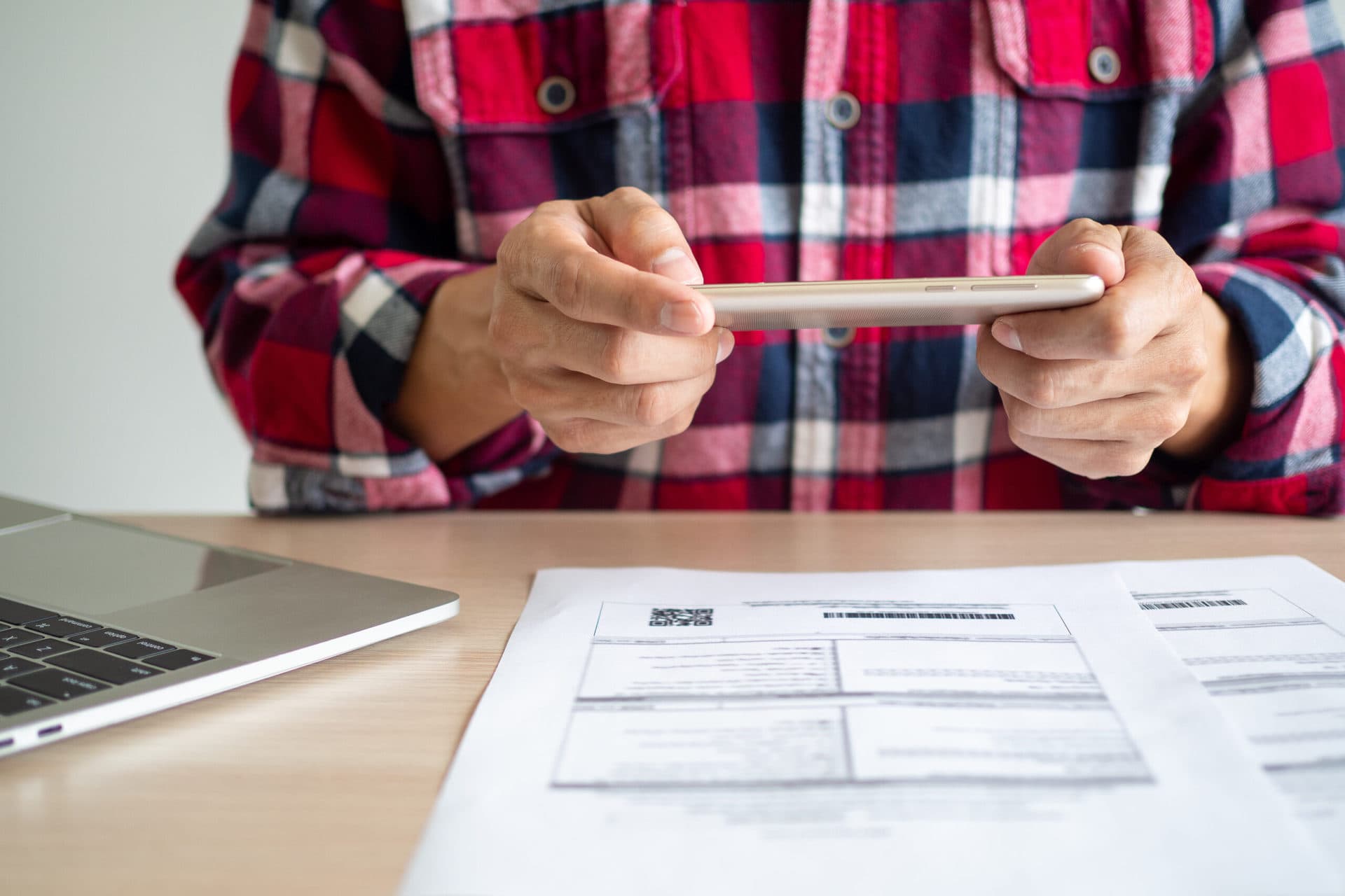 Image of man taking photo of receipt for cloud bookkeeping