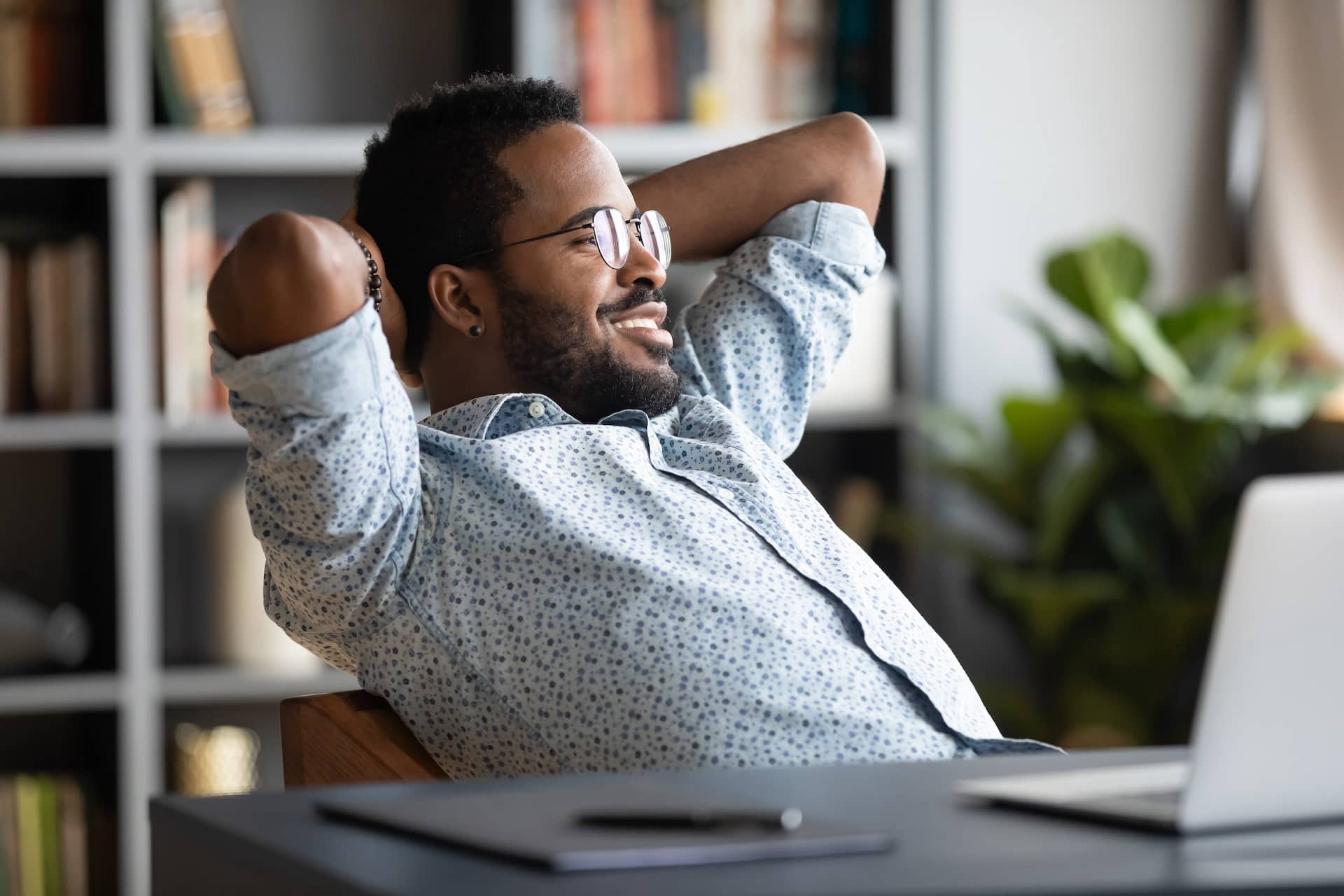 Man leading back at his desk for tax preparation