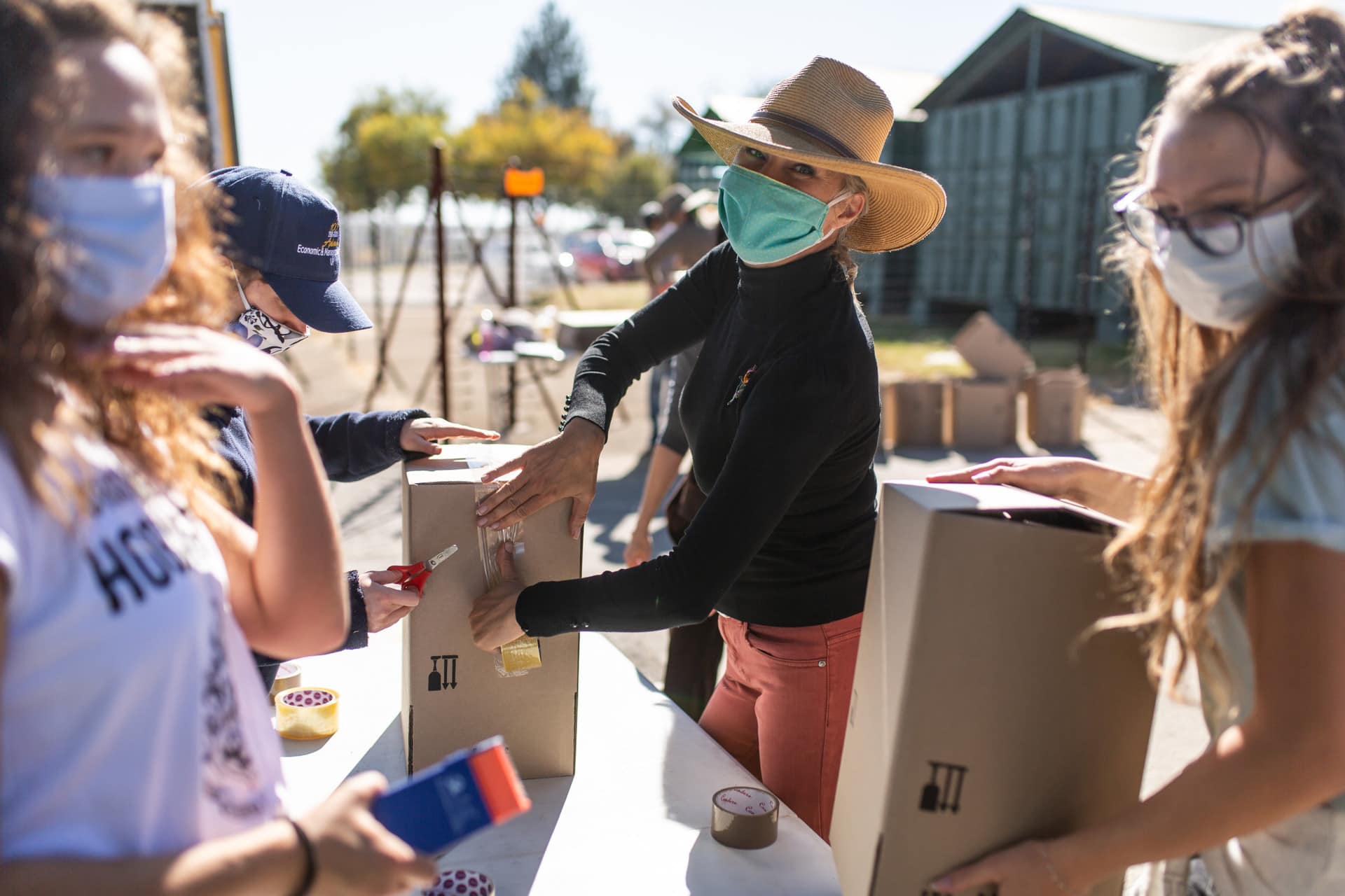 Volunteers working outdoors wearing face masks for not-for-profit